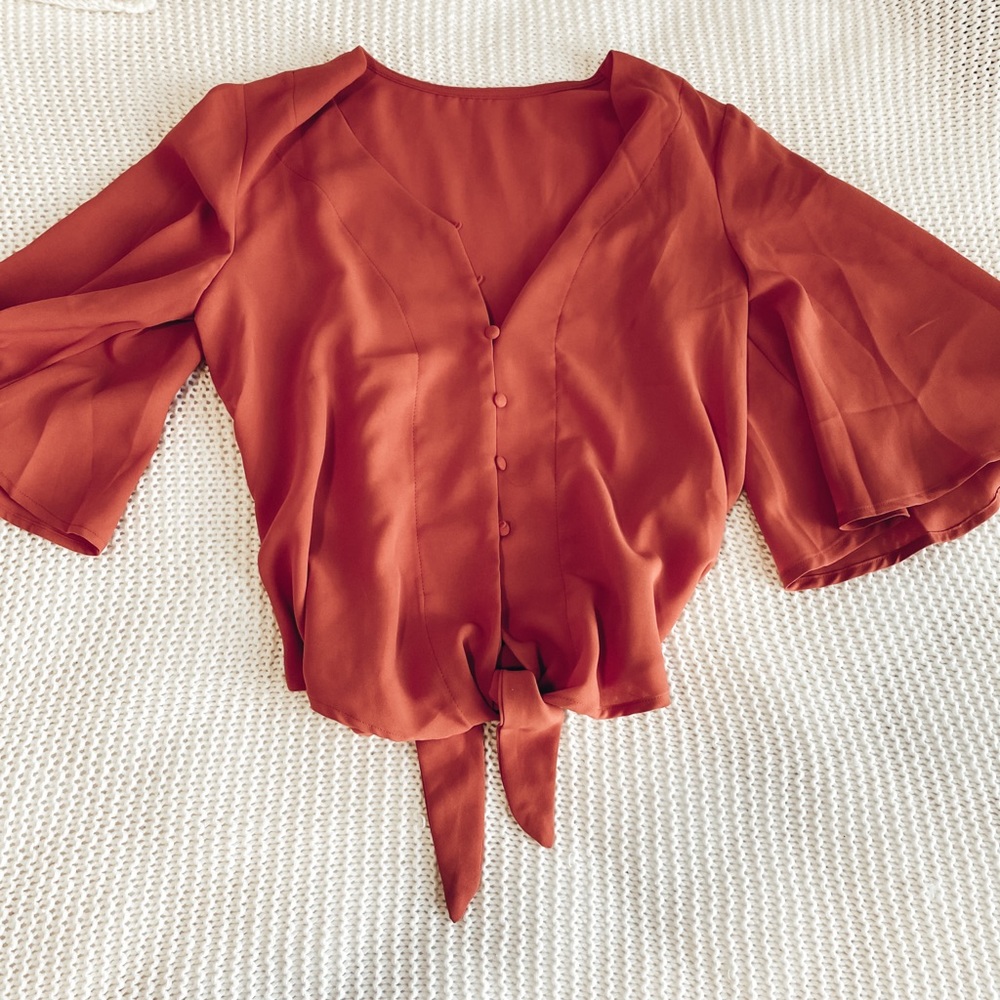 Button front blouse with tie detail at bottom
